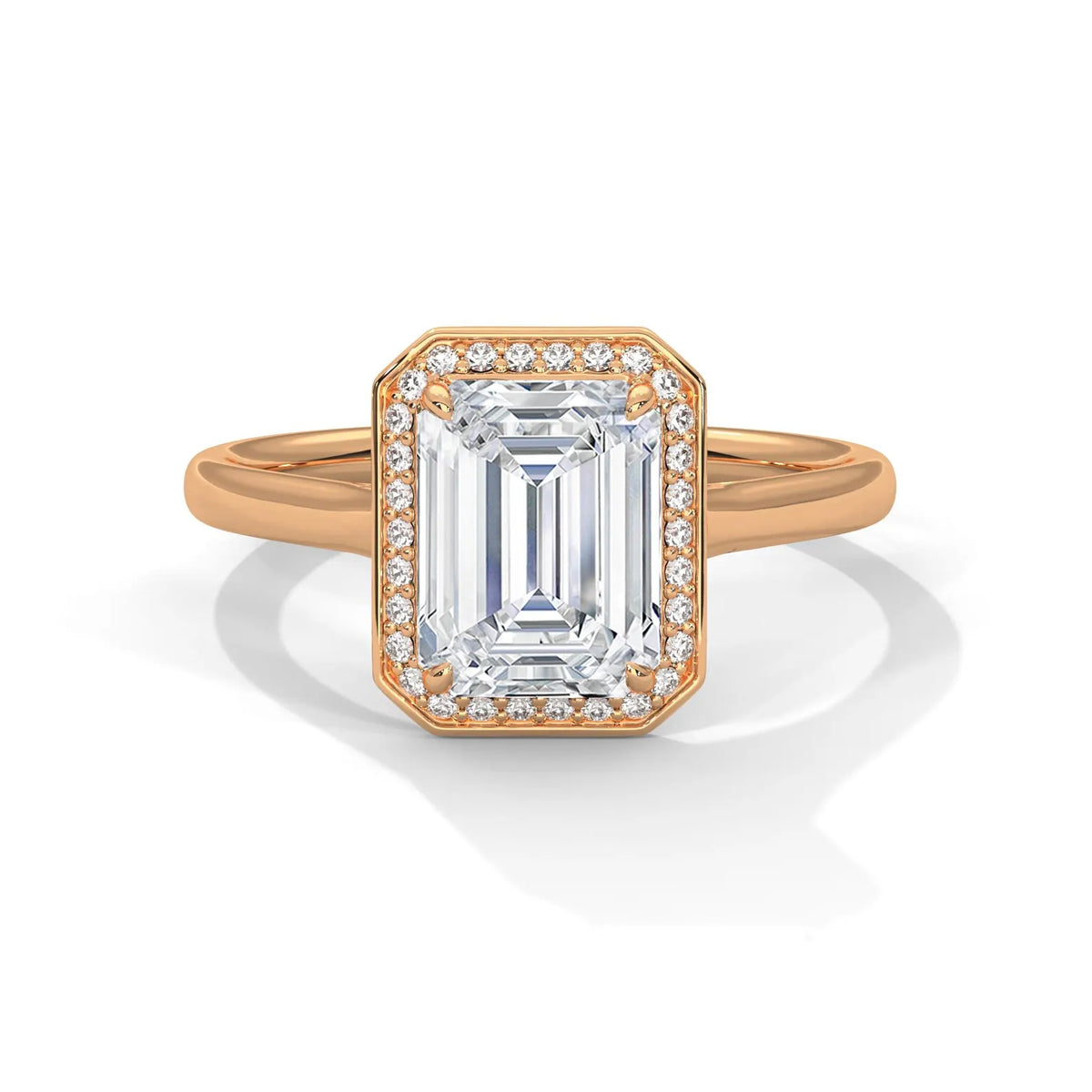 Top front view of a 4 CT emerald cut lab-grown diamond engagement ring with a pave halo frame in 14K rose gold.