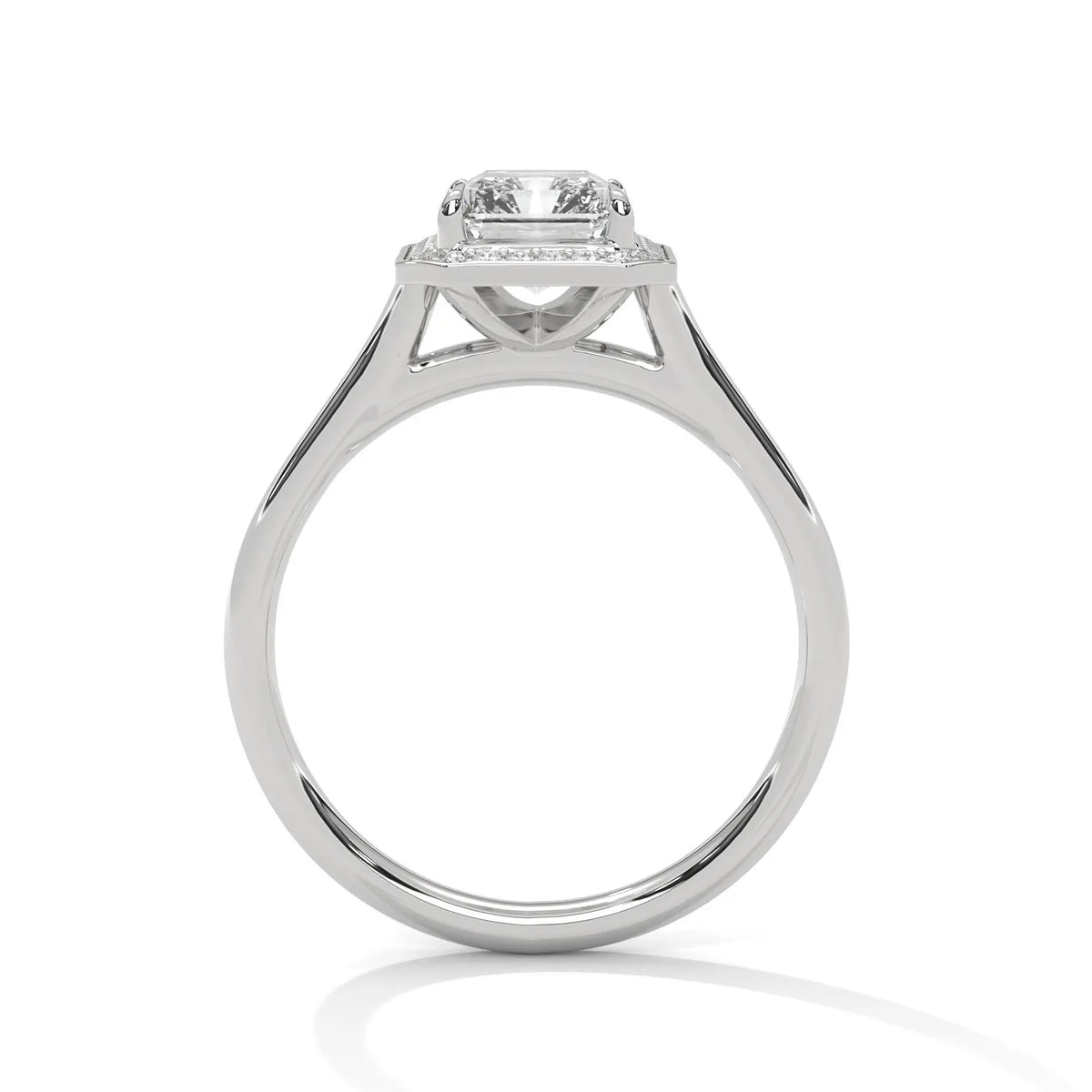 Direct side profile view of a 4 carat emerald cut lab diamond engagement ring showing open gallery arches in white gold.