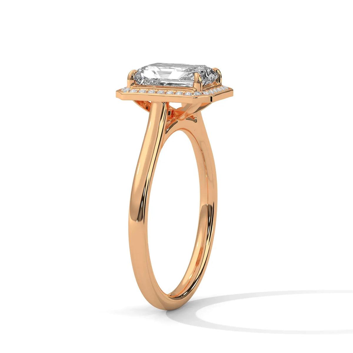 Angled side view of a 4 CT emerald cut lab-grown diamond engagement ring on a plain rose gold band.