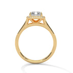 Side profile view showing cathedral bridge setting of a 4 CT emerald cut lab diamond solitaire ring in yellow gold.