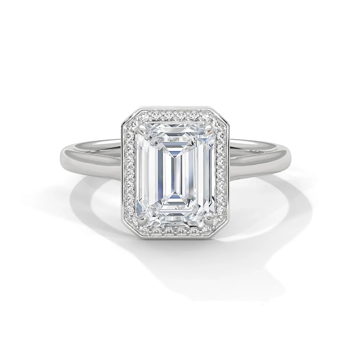 Top front view of a 4 CT emerald cut lab-grown diamond engagement ring with micro-pave halo border in 14K white gold.
