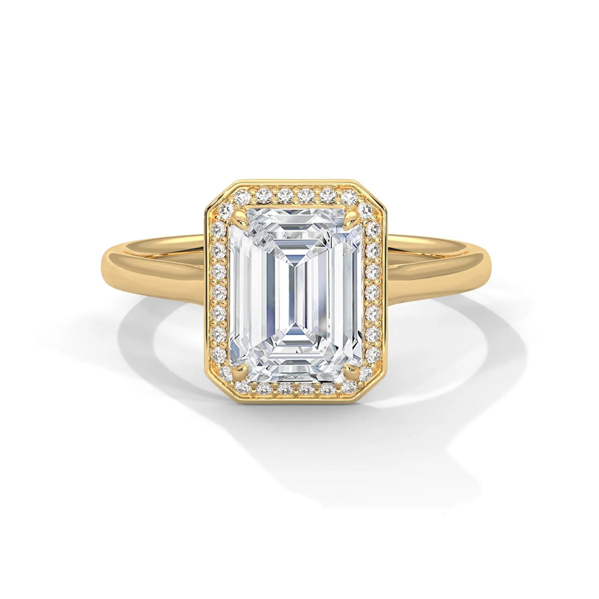 Top front view of a 4 CT emerald cut lab-grown diamond engagement ring with pave frame halo on a plain yellow gold band.