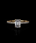 Front view of an IGI certified 2 carat emerald cut lab diamond engagement ring set on a delicate yellow gold micro-pave band.