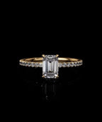 Front view of an IGI certified 2 carat emerald cut lab diamond engagement ring set on a delicate yellow gold micro-pave band.