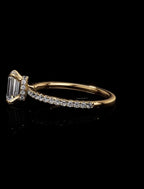 Gold ring with diamond accents on a black background