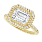 Angled front view of a 3 CT East-West emerald cut lab-grown diamond ring featuring a bezel halo and pave accent band.