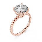 High three-quarter angle view of a 3 CT round brilliant lab diamond ring in 14K rose gold with a beaded band.