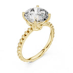 Gold ring with a large clear gemstone on a white background