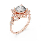 Angled view of a 3 CT round lab diamond engagement ring featuring a star halo and intertwined pavé band in 14K rose gold.