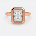 Direct front view of a 3 CT radiant lab-grown diamond engagement ring in a rose gold milgrain bezel setting.