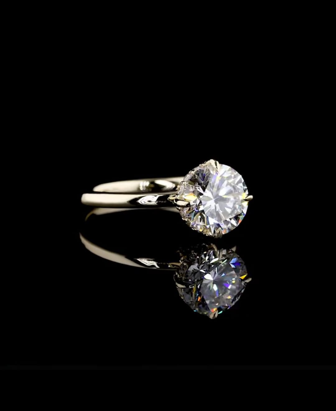 A classic solitaire engagement ring featuring a round brilliant-cut diamond set in a yellow gold band