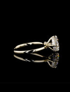 A yellow gold ring with a large clear gemstone in a triangular setting