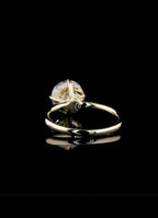 Bottom interior view of a plain high-polish yellow gold ring band supporting a 2 carat round brilliant lab-grown diamond setting.