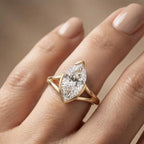 Angled lifestyle view of a 3 CT vertical marquise lab grown diamond solitaire ring on a hand in warm yellow gold.