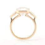 Architectural side profile of a 3 carat Asscher cut lab diamond bezel engagement ring in polished yellow gold.
