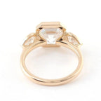 Bottom gallery view showcasing the open pavilion construction of a yellow gold bezel set Asscher ring.