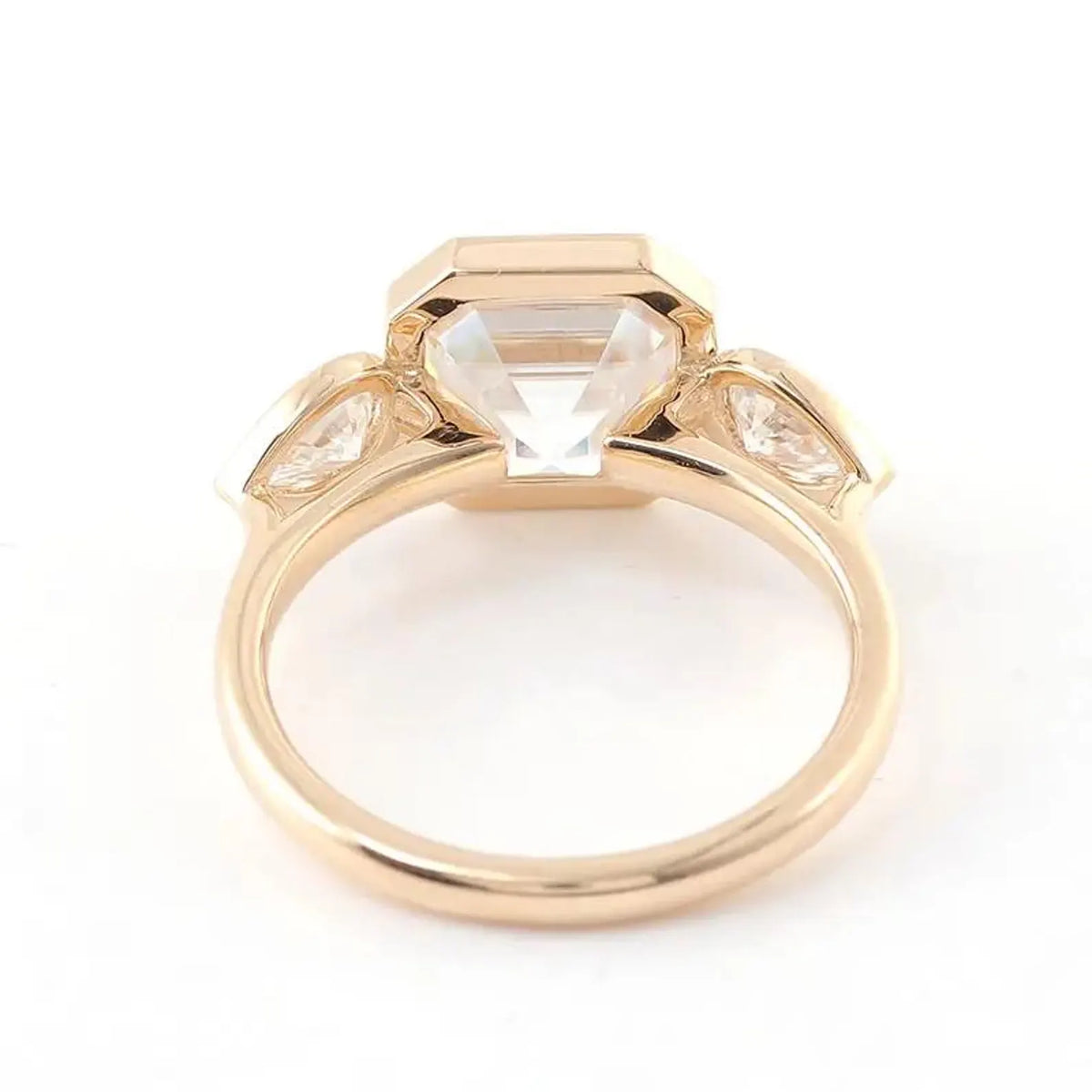 Bottom gallery view showcasing the open pavilion construction of a yellow gold bezel set Asscher ring.