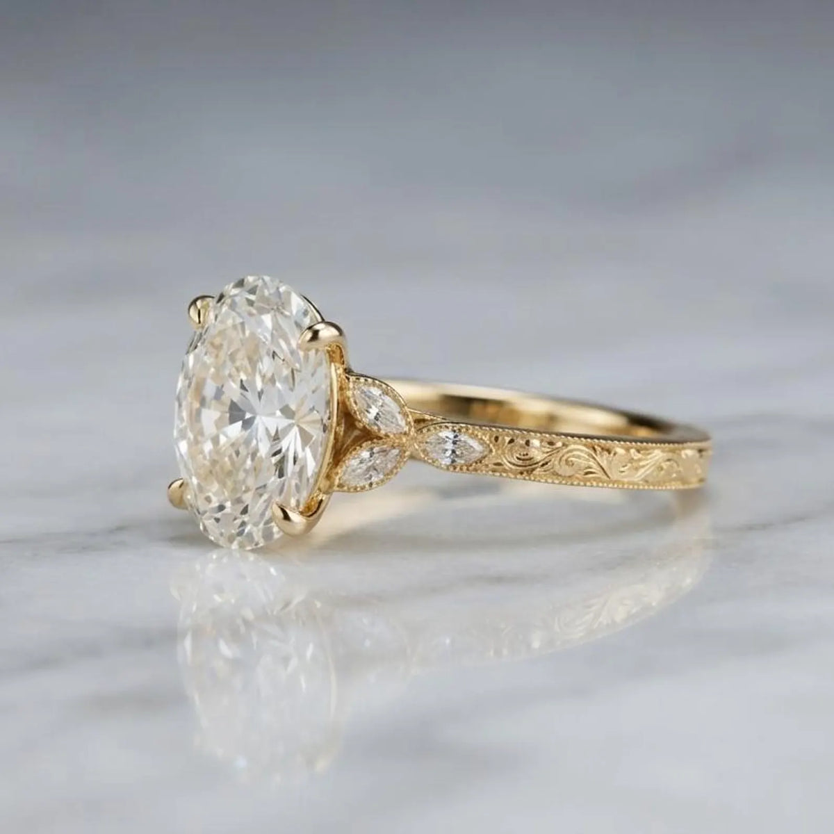 Side profile view of a 4 CT oval lab grown diamond ring on white marble showing intricate vintage scroll engraving on yellow gold.