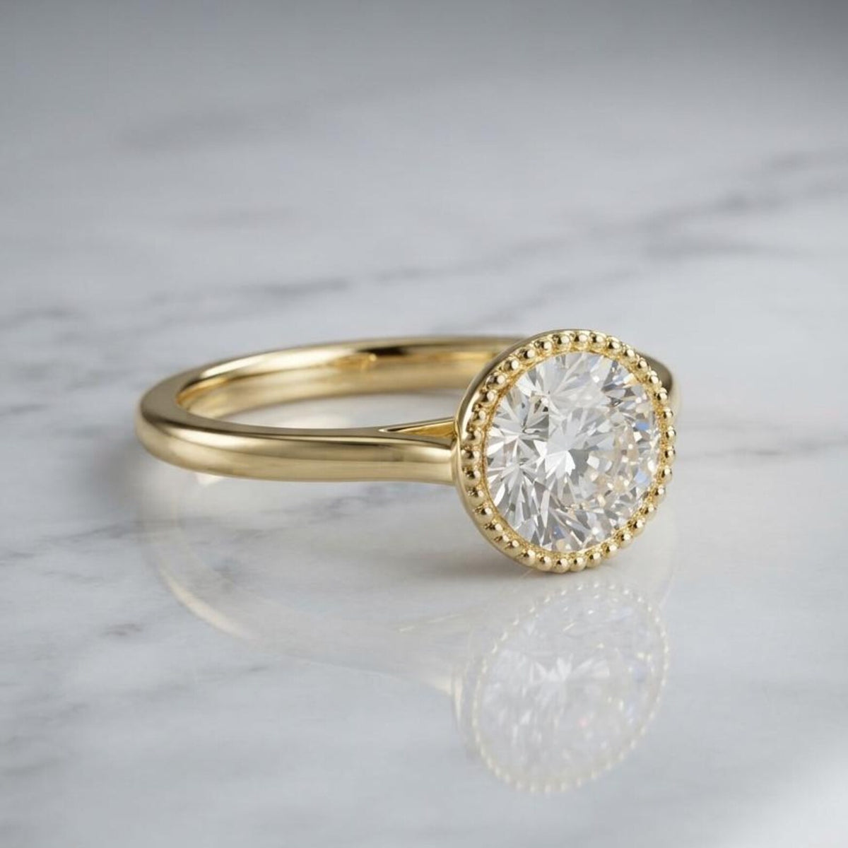 3 CT round lab grown diamond engagement ring in a beaded milgrain bezel setting in yellow gold resting on white marble.