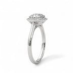 Angled side view of a white gold 3 CT cushion lab diamond halo engagement ring showing cathedral setting.