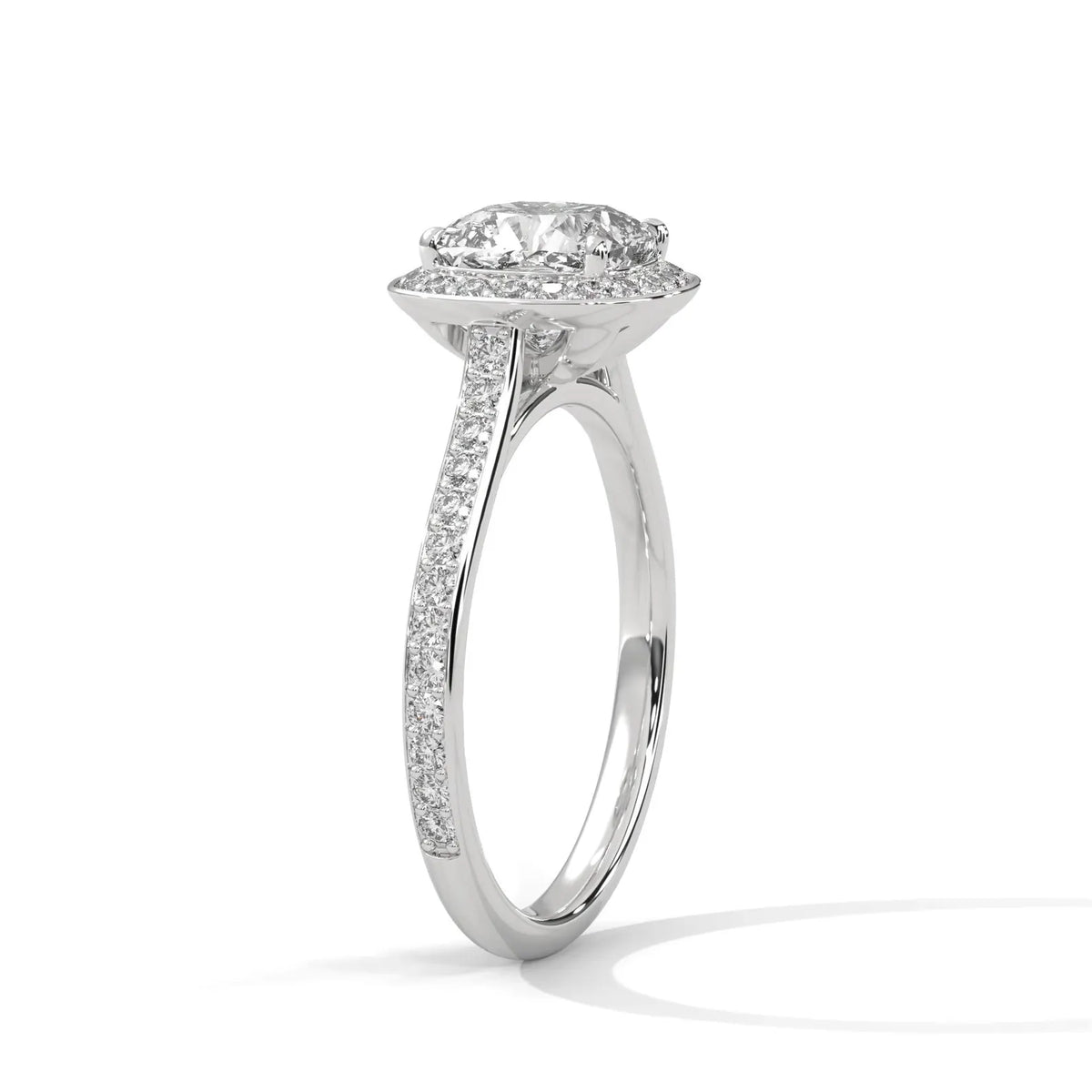 Angled side view of a white gold 3 CT cushion cut lab diamond engagement ring showing cathedral setting and pavé band.