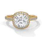 Top-down view of a 3 CT cushion cut lab grown diamond halo engagement ring with pavé band in 14k yellow gold.