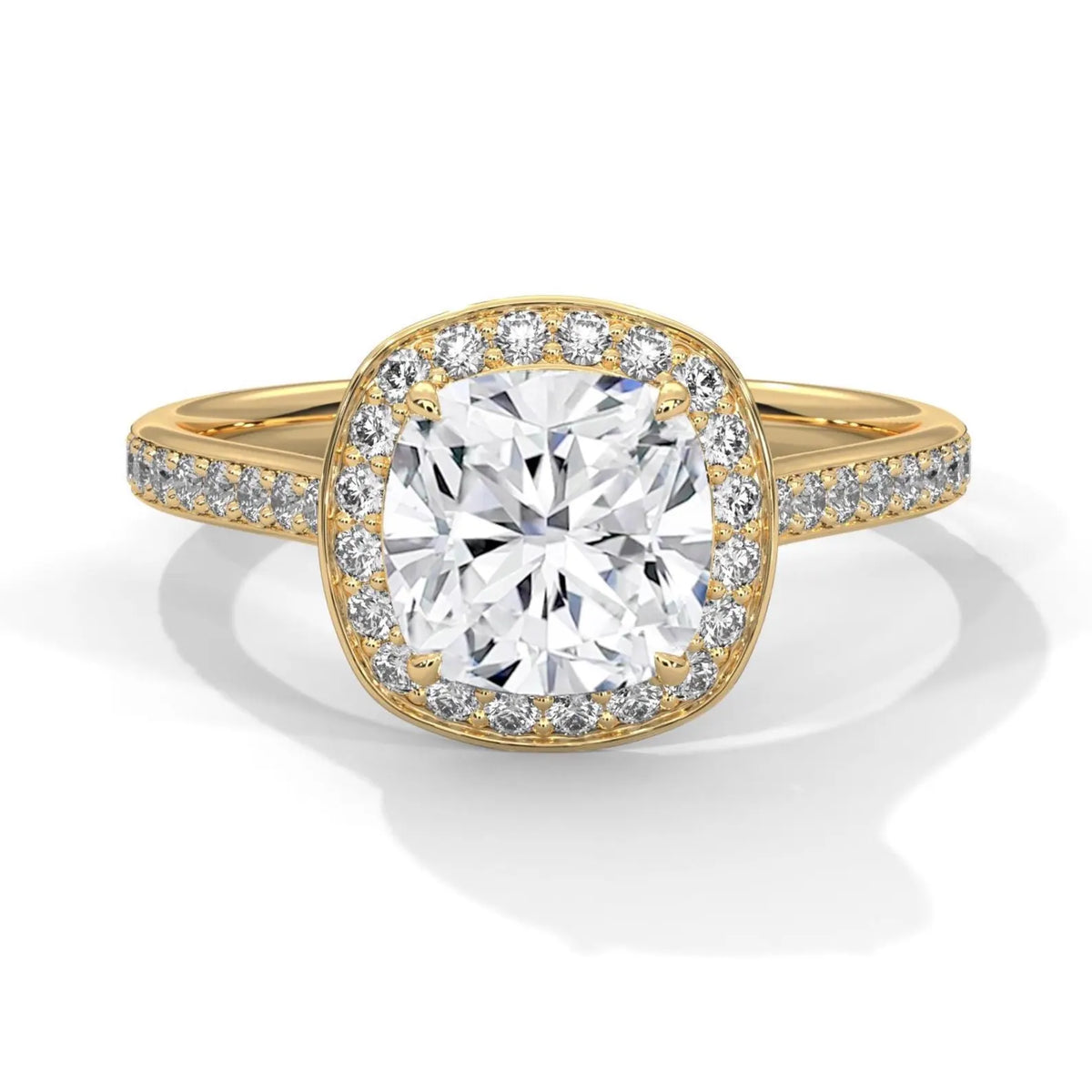 Top-down view of a 3 CT cushion cut lab grown diamond halo engagement ring with pavé band in 14k yellow gold.