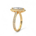 Angled side view of a yellow gold 4 CT marquise cut lab diamond halo engagement ring with pavé band.