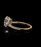 Side profile of an IGI certified 2 carat oval lab diamond ring highlighting a diamond-accented hidden halo collar beneath the center stone.