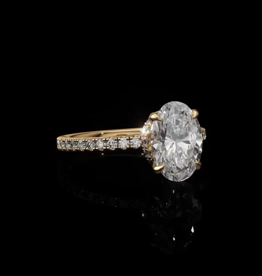 Angled view of a 2 CT oval lab-grown diamond ring displaying brilliant faceting and a sparkling diamond pavé shank.
