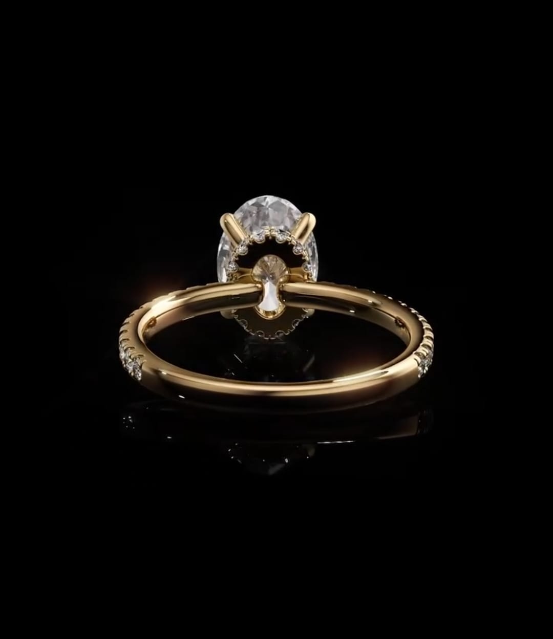 Under-gallery view of a yellow gold oval diamond engagement ring showcasing the interior setting collar and solid polished band base.