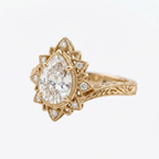 Angled side profile of a yellow gold 3 CT pear cut lab diamond ring showcasing hand-carved scrollwork shank.