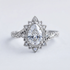 Top-down view of a 3 CT pear cut lab grown diamond vintage starburst halo engagement ring in white gold.