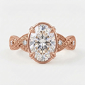 Top-down view of a rose gold 4 CT oval cut lab grown diamond ring with vintage engraved twisted band.