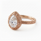Angled perspective view of a rose gold 3 CT pear cut lab grown diamond engagement ring with filigree lace halo and floral carved shank.
