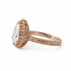 Side profile view of a rose gold 3 CT pear cut lab diamond ring showcasing hand-engraved floral shank and filigree basket.