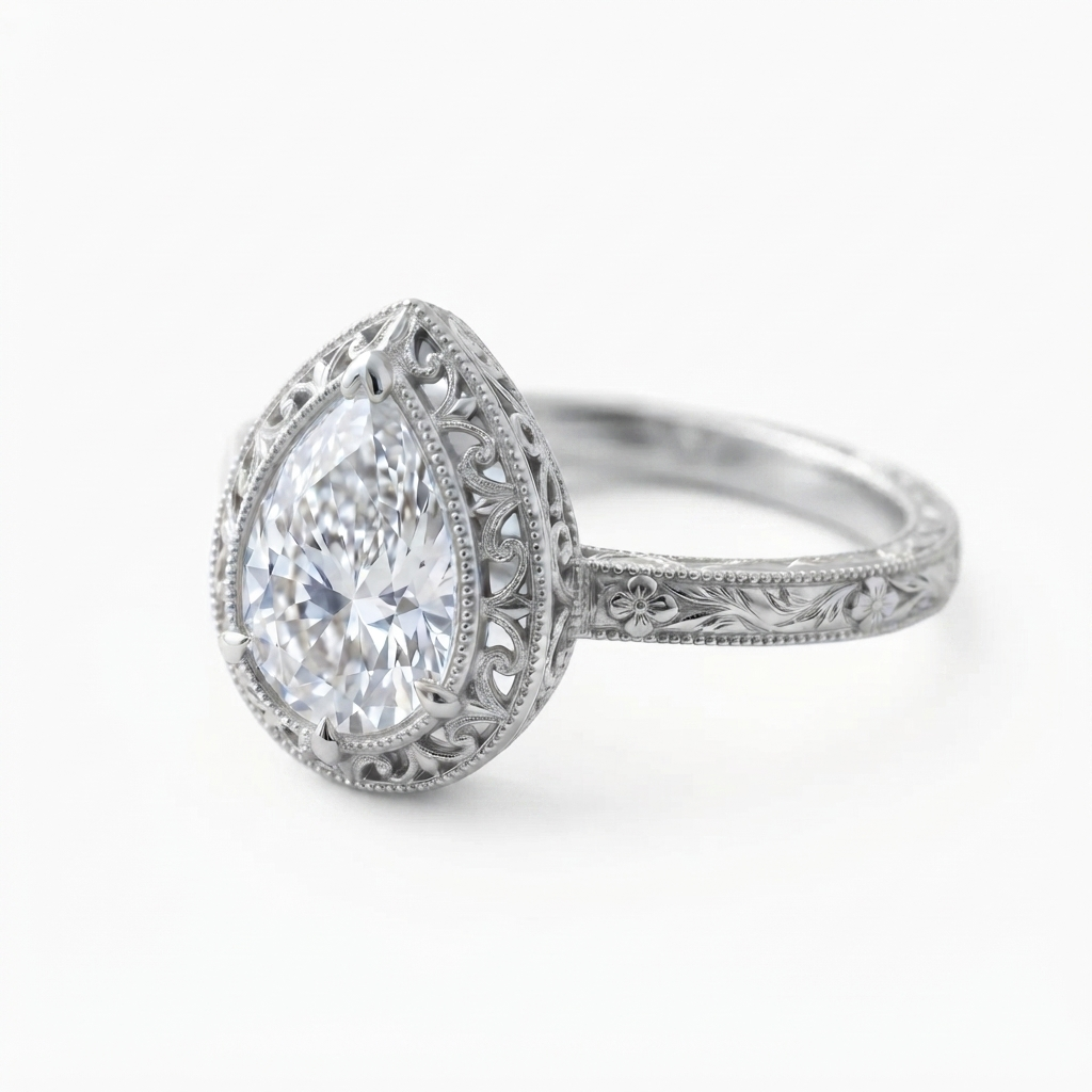 Angled perspective view of a white gold 3 CT pear lab diamond engagement ring with intricate scrollwork halo and milgrain band.
