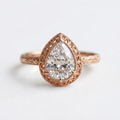 Top-down view of a rose gold 3 CT pear cut lab grown diamond engagement ring with milgrain-accented filigree crown.