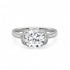 Top view of a 3 CT round cut lab grown diamond engagement ring in white gold featuring a curved pavé diamond collar.
