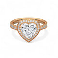 Top-down view of a 3 CT heart-cut lab grown diamond ring with a halo setting and pavé band in rose gold.