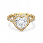 Top-down view of a 3 CT heart-cut lab grown diamond halo ring with accent diamonds on a yellow gold band.