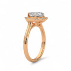 Three-quarter side view of a 3 carat heart-shaped lab diamond engagement ring with halo on a plain rose gold band.