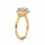 Three-quarter side angle of a yellow gold 3 CT heart cut lab diamond ring with a halo setting.