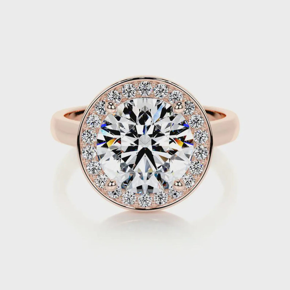 Direct top-down view of a 4 carat round cut lab diamond halo ring on a rose gold plain band.
