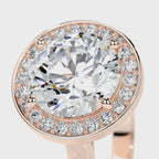 Close-up angled view of a 4 CT round cut lab grown diamond halo ring in rose gold.
