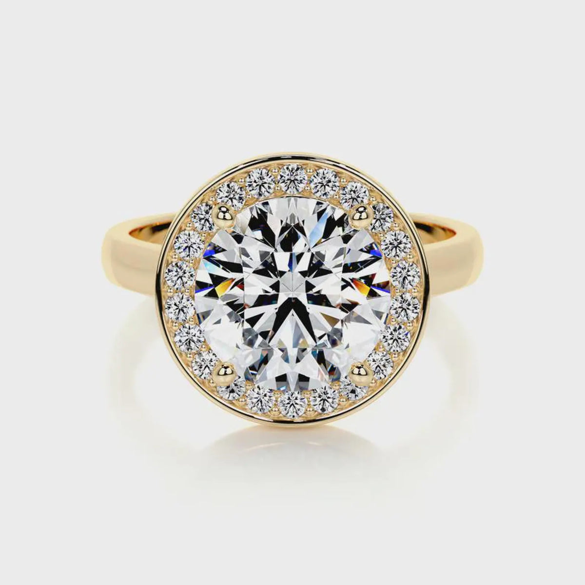 Direct top-down view of a 4 CT round cut lab grown diamond engagement ring in yellow gold.
