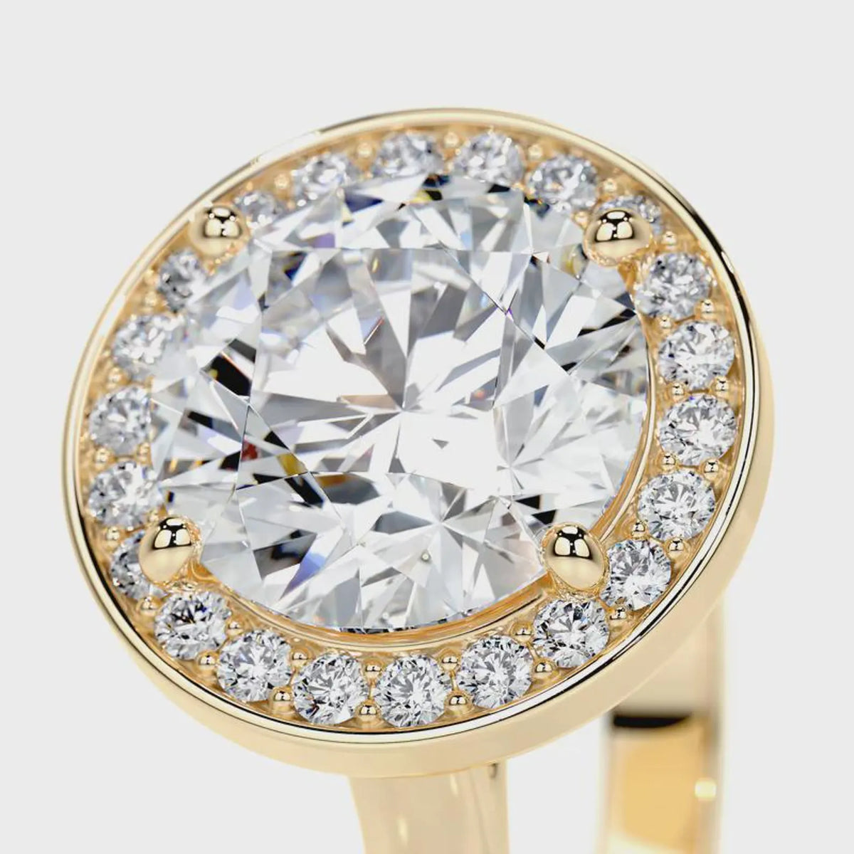 Close-up angled view of a 4 CT round cut lab diamond halo ring in yellow gold.