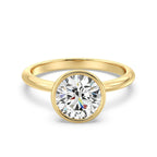 Front view of a 3 CT round cut lab grown diamond bezel engagement ring in yellow gold.