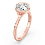 Angled perspective view of a rose gold 3 carat round lab diamond bezel engagement ring.