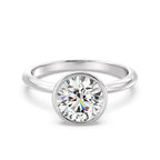 Front view of a 3 CT round cut lab grown diamond bezel solitaire ring in white gold.